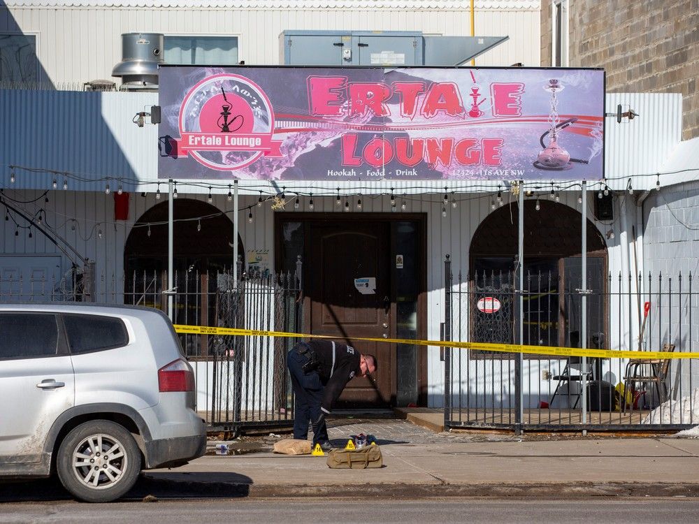 An Edmonton Police Service member investigates the scene of a shooting at Ertale Lounge on Saturday, March 12, 2022. Four people have now been charged in the shooting, including a Parkland County man accused of being a 