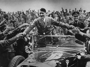 Adolf Hitler is shown in the 1930s being welcomed by supporters at Nuremberg.