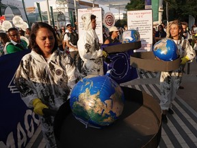 Activists, including some some dressed to represent the oil and gas industry and pretending to heat the globe in giant frying pans, march in protest on day nine of the UNFCCC COP28 Climate Conference at Expo City Dubai on Dec. 09, 2023 in Dubai, United Arab Emirates.