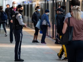 A peace officer works on the platform at the Century Park LRT station, on July 27, 2021.