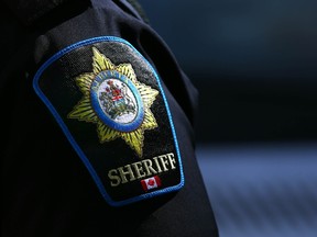 Alberta Sheriff’s Shoulder Sticks in Downtown Calgary on Thursday, March 23, 2023