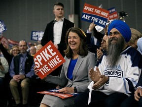 Alberta Premier Danielle Smith and MP Tim Uppal attend Pierre Poilievre's 'Spike the Hike - Axe the Tax' rally in Edmonton on Wednesday, March 27, 2024.