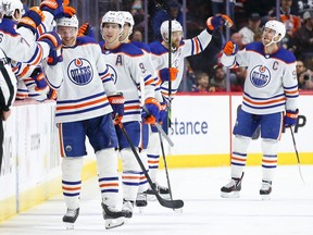 OTTAWA, CANADA - MARCH 24: Zach Hyman #18 of the Edmonton Oilers celebrates his 50th goal of the season with his teammates on the bench during the second period against the Ottawa Senators at Canadian Tire Centre on March 24, 2024 in Ottawa, Ontario, Canada.