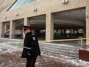 An Edmonton Police officer is seen at City Hall during an investigation in Edmonton on January 23, 2024. A man facing terrorism charges after an armed attack on Edmonton City Hall in January will have to wait a while longer before being able to seek bail.
