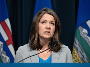 Alberta Premier Danielle Smith answers questions at a news conference in Calgary on Thursday, Feb. 1, 2024. Smith says the province has stepped in to pay an outstanding $25,000 bill to a hotel where a social services agency sent clients in need of support after their discharge from hospital.