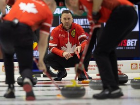 Canada skip Brad Gushue watches his team on the ice at the 2024 Montana's Brier inside the Brandt Centre.