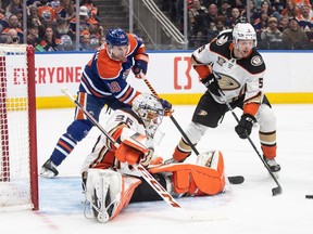 Anaheim Ducks goalie John Gibson (36) makes the save as Edmonton Oilers' Zach Hyman (18) and Urho Vaakanainen (5) look for the rebound during second period NHL action in Edmonton on Saturday March 30, 2024.Jason Franson/THE CANADIAN PRESS