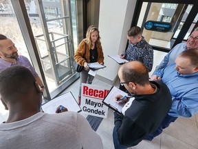 Downtown office workers sign the recall petition for Mayor Jyoti Gondek in a Plus-15 on Tuesday, February 20, 2024.