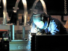 A welder is seen working in a factory in Quebec City in this photo from Feb. 28, 2012.