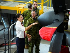 Prime Minister Justin Trudeau is given a tour of a training facility prior to a press conference regarding the release of Canada's new defence policy at CFB Trenton on Monday, April 8, 2024. THE CANADIAN PRESS/Sean Kilpatrick