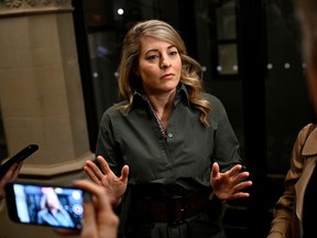 Minister of Foreign Affairs Melanie Joly responds to questions from reporters as she arrives for a meeting of the Liberal caucus in West Block on Parliament Hill in Ottawa, on Wednesday, April 10, 2024. THE CANADIAN PRESS/Justin Tang