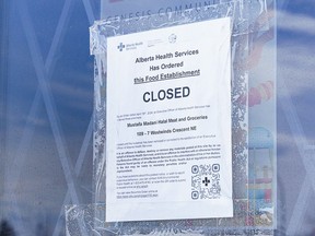 Closure signage pictured at Mustafa Madani Halal Meat and Groceries in northeast Calgary on Monday, April 22, 2024. AHS issued closure orders for several grocery stores accused of buying and selling uninspected meat.