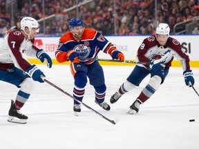 Connor McDavid #97 of the Edmonton Oilers battles against Devon Toews #7 and Cale Makar #8 of the Colorado Avalanche during the second period at Rogers Place on April 5, 2024, in Edmonton.