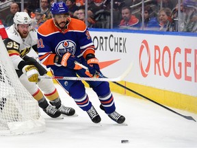 Evander Kane #91 of the Edmonton Oilers and Anthony Mantha #39 of the Vegas Golden Knights battle for the puck at Rogers Place on April 10, 2024, in Edmonton.
