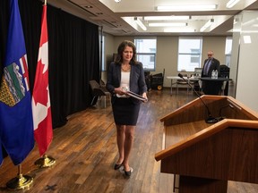 Alberta Premier Danielle Smith makes her way to the podium to introduce legislation addressing agreements between the federal government and provincial entities in Edmonton on Wednesday April 10, 2024. A national organization of post-secondary teachers is calling on Alberta to either change a proposed gatekeeping bill or scrap it altogether.