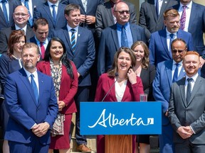 Alberta Premier Danielle Smith poses for a picture with members of her cabinet.