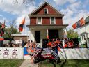 (left to right) Edmonton Oilers' fans Warren Sillanpaa and and Al Laurence decorate the fence in front of Sillanpaa's home in Edmonton's Oliver neighbourhood, Friday May 24, 2024. 