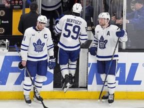 Toronto Maple Leafs forward Tyler Bertuzzi (59) leaves the ice between John Tavares (91) and Morgan Rielly (44) after the team lost to the Boston Bruins in overtime during Game 7 of an NHL hockey Stanley Cup first-round playoff series, Saturday, May 4, 2024, in Boston.
