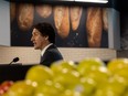 Prime Minister Justin Trudeau speaks at a podium during a planned media event at the Harbour Landing Co-op in Regina in April, 2023.
