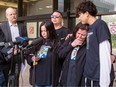 Family of Steven Nguyen speak outside the courthouse on Wednesday, May 15, 2024, including his sister Melisa Solano, brother Chris Nguyen, mother Maria Nguyen and nephew Christian Nguyen as their lawyer Tom Engel, left, listens. Steven Nguyen was shot and killed by Const Alex Doduk of the Edmonton Police Service in 2021. They are speaking about the ASIRT report that has been released on the incident which recommends the officer be charged with a criminal offence.
