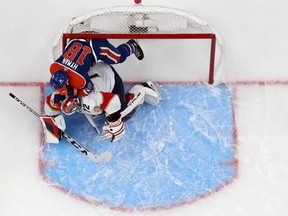 Zach Hyman of the Edmonton Oilers climbs on Sergei Bobrovsky of the Florida Panthers during the third period of Game 3.