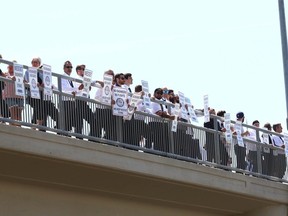 WestJet picketers line up on 19 St. N.E. over top of Airport Tr. in Calgary on Saturday.