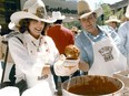 Mayor Ralph Klein with wife Colleen ladle up chili during the annual mayor's Stampede brunch at Stephen Avenue Mall on July 10, 1985.