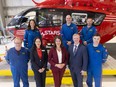 STARS CEO and President Katherine Emberly, Premier Danielle Smith, and MLA Martin Long pose with crew STARS members in front of the Airbus H145 helicopter at their Calgary base on Tuesday, June 4, 2024.