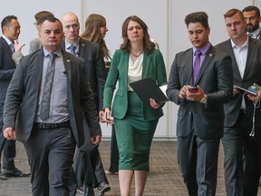 Premier Danielle Smith walks with staff and security following a session at the Global Energy Show in Calgary on Wednesday, June 12, 2024.