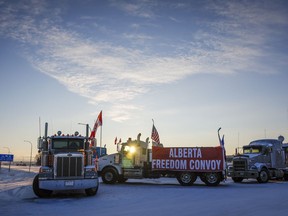 A truck convoy of anti-COVID-19 vaccine mandate demonstrators block the highway at the busy U.S. border crossing in Coutts, Alta., Wednesday, Feb. 2, 2022. A police phone expert is to continue testifying today at the trial for two men charged with conspiracy to commit murder at the border blockade at Coutts, Alta.