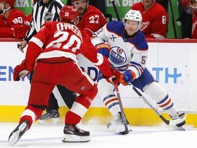 Edmonton Oilers center Jeff Skinner (53) passes the puck against Detroit Red Wings defenseman Albert Johansson (20) during the first period of an NHL hockey game Sunday, Oct. 27, 2024, in Detroit.