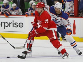 Detroit Red Wings center Dylan Larkin (71) is guarded by Edmonton Oilers defenseman Darnell Nurse (25) during the second period of an NHL hockey game Sunday, Oct. 27, 2024, in Detroit.