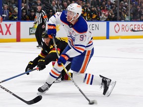 Connor McDavid #97 of the Edmonton Oilers takes a shot during the second period of their NHL game against the Vancouver Canucks at Rogers Arena on January 18, 2025 in Vancouver, British Columbia, Canada.