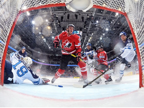 MOSCOW, RUSSIA - MAY 22: Canada's Connor McDavid #97 gets the puck past Finland's Mikko Koskinen #19 to score the gold-medal goal at the 2016 IIHF Ice Hockey World Championship.