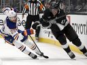 In the first phase of the NHL hockey game in Los Angeles on Saturday, April 5, 2025, Anze Kopitar drives the puck past Edmonton Oiler right-wing Connor Brown.