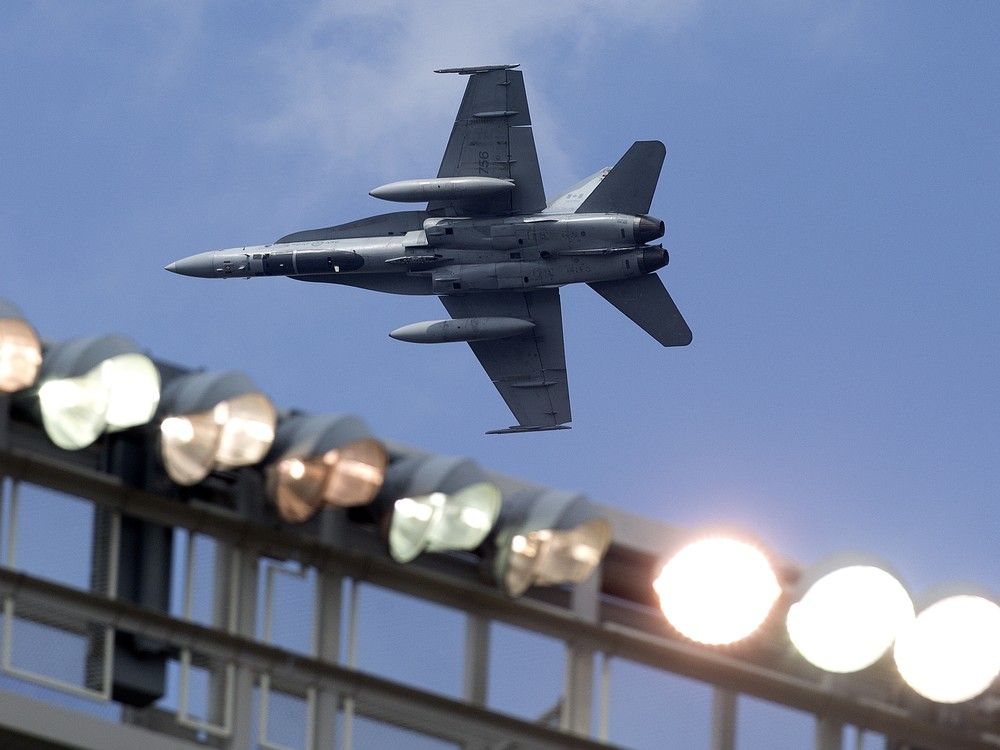 A CF-18 jet does a flyover before the Edmonton Elks' and Hamilton Tiger-Cats CFL game at Commonwealth Stadium, in Edmonton Saturday Aug. 2, 2025.