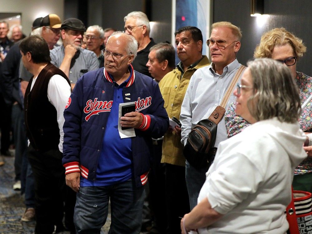  People wait for the doors to open at an Alberta Next Panel in-person town hall, in Edmonton Thursday Aug. 14, 2025.