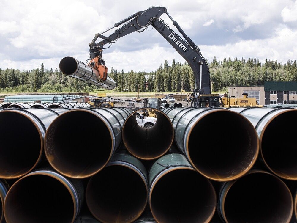 Pipe for the Trans Mountain pipeline expansion is unloaded in Edson on June 18, 2019. The Trans Mountain pipeline received $320 million in subsidies from the Canadian and Alberta governments in the first half of 2019, says a new report by an economic institute that analyzes environmental issues.