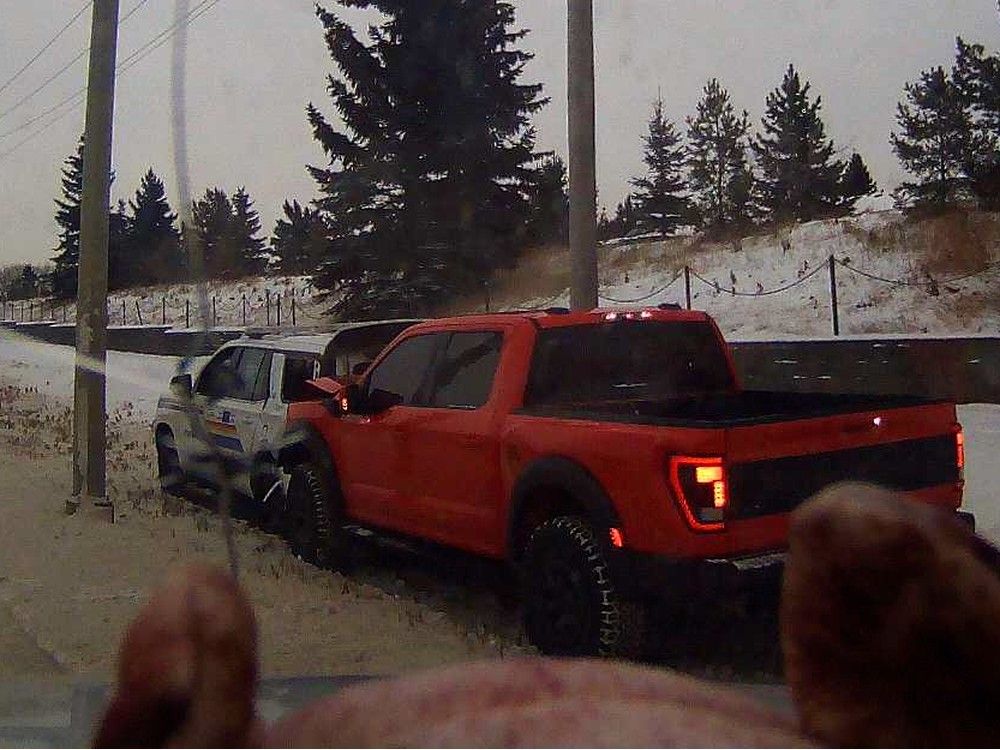 A Leduc is man facing charges, including aggravated assault on a police officer, after an RCMP cruiser was hit from behind by a Ford Raptor pickup truck on Monday, Dec. 8, 2025.