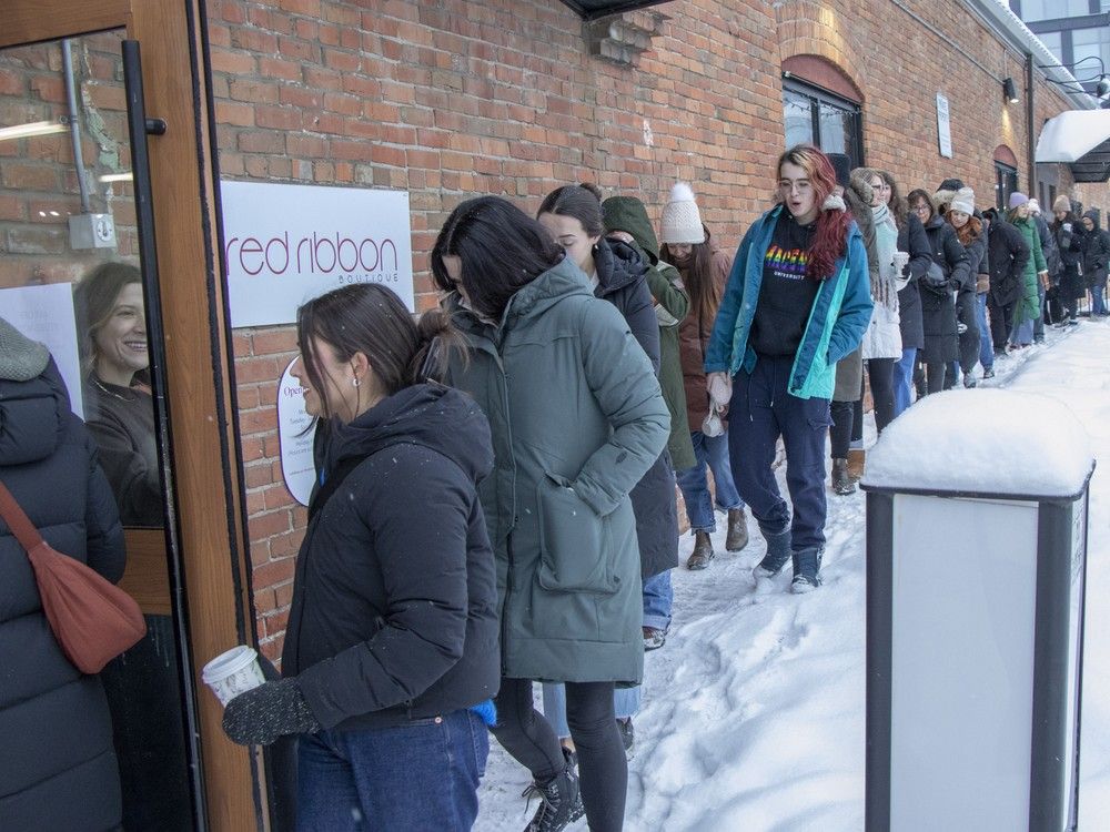 Boxing Day shoppers lined up outside Red Ribbon Boutique near High Street to take advantage of the 40 percent sale on fashion in Edmonton on Friday, December 26, 2025. While some retailers were busy with Friday sales, mall retailers were looking at slower activity than in previous years.