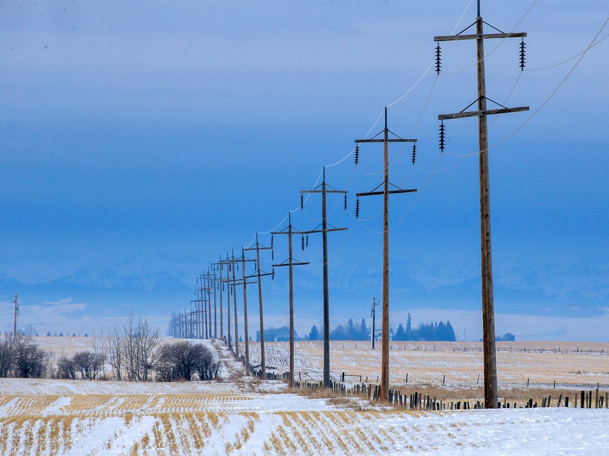 Power lines stretch towards the west across snowy prairie south of Calgary on Tuesday, Dec. 13, 2022.