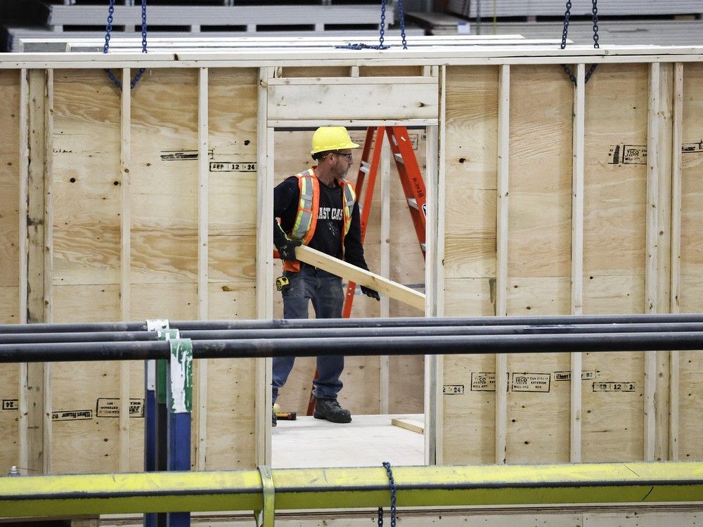 An employee works on a modular home component at NRB Modular Solutions in Calgary, Friday, April 5, 2024.