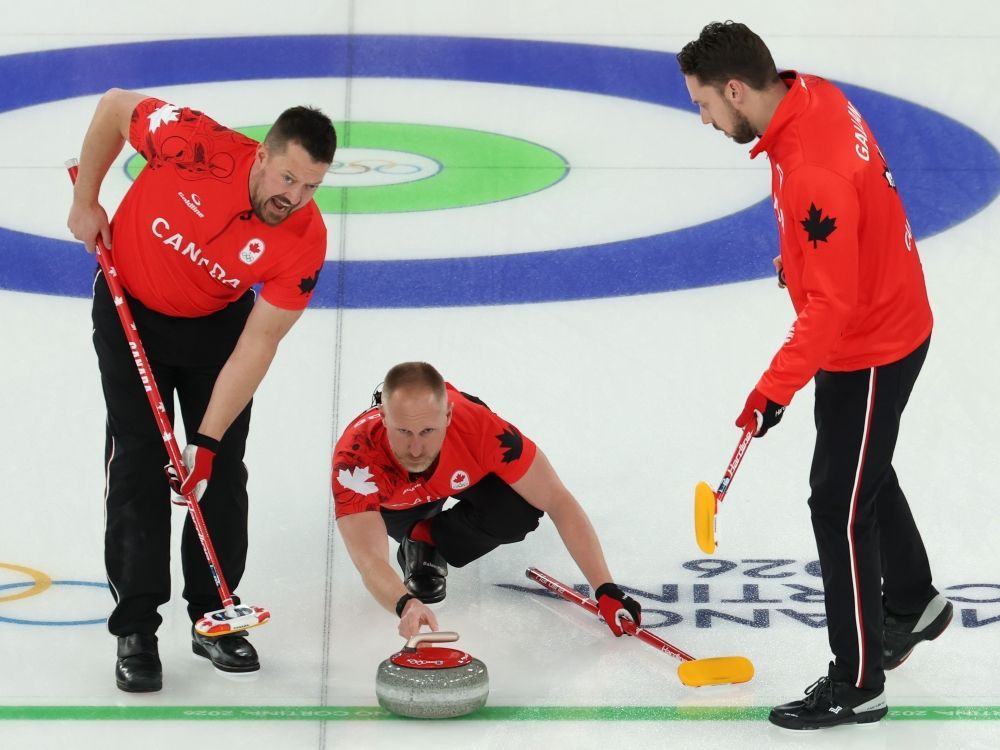 Brad Jacobs, Ben Hebert and Brett Gallant of Team Canada compete during Men's Round Robin agaisnt Team Great Britain at the Milano-Cortina 2026 Winter Olympic Games.