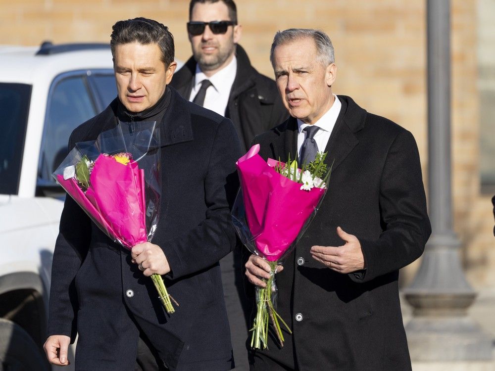 At the memorial, Carney took a few minutes to speak to local MLA Larry Neufeld while the majority of reporters and camera people stood across the street.
