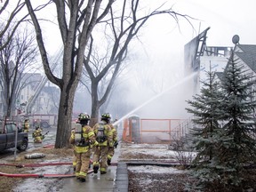 Firefighters doused a three story multi-plex in Garneau with water after a fire was spotted on the top floor. The two adjacent homes suffered heavy water damage after they were evacuated in Edmonton on Thursday, March 19, 2026.