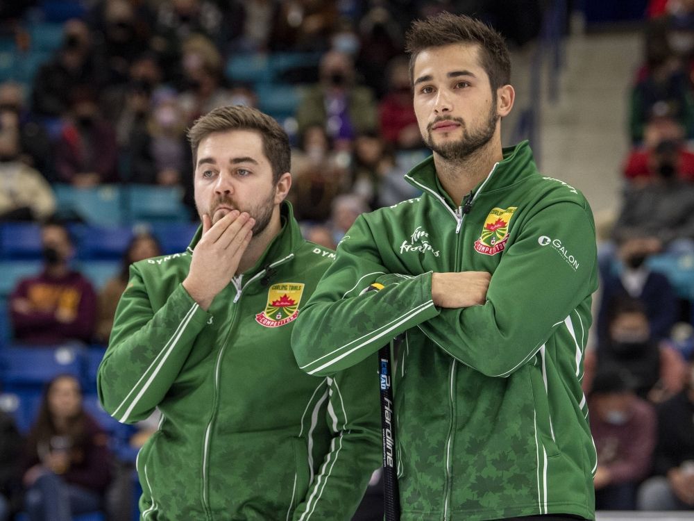 Matt Dunstone (left) and Colton Lott look on during the 2021 Canadian Olympic curling trials.