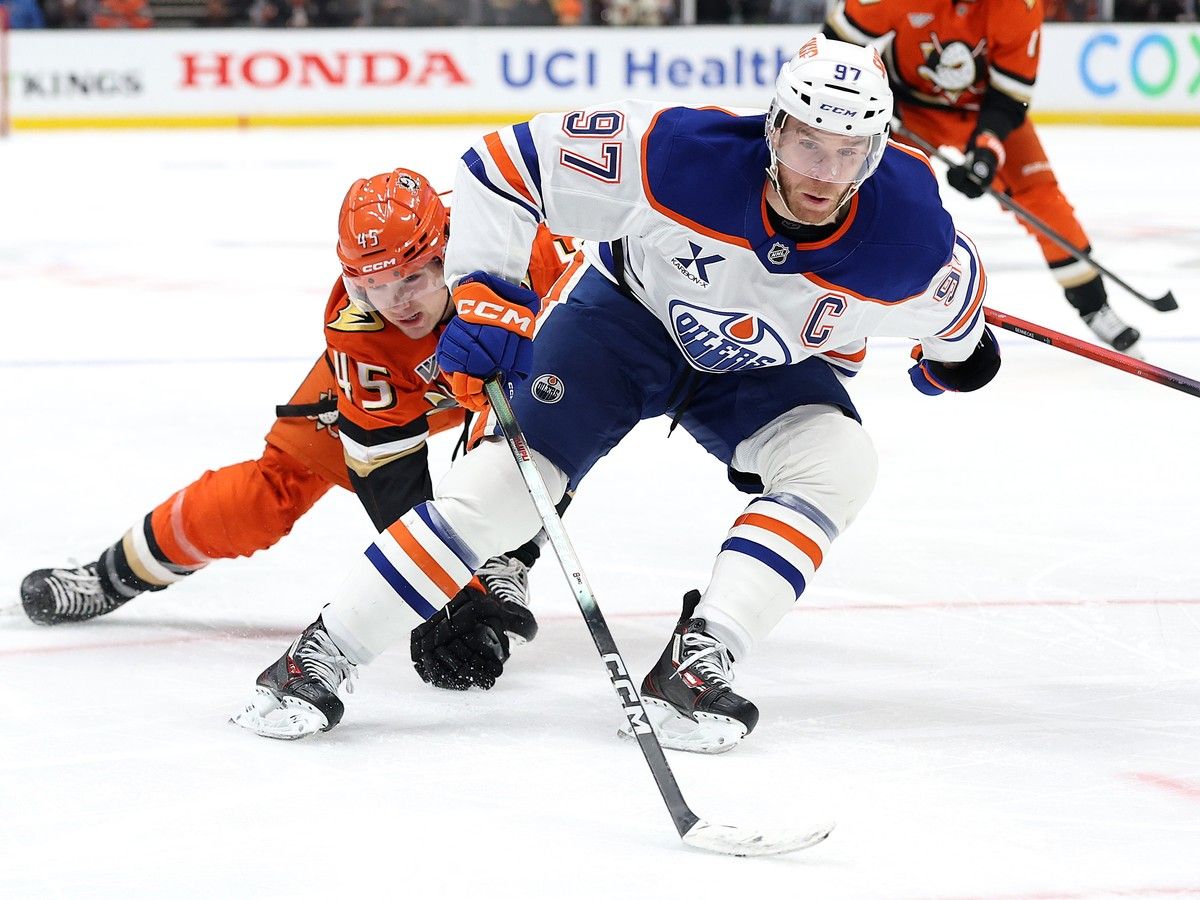 Connor McDavid skates around Beckett Sennecke