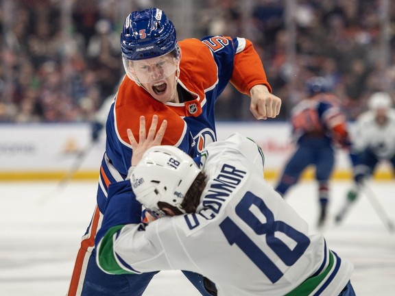 Connor Murphy (5) of the Edmonton Oilers, fought with Drew O'Connor (18) the Vancouver Canucks in the second period at Rogers Place on Thursday, April 16, 2026. Photos by Shaughn Butts - Postmedia
