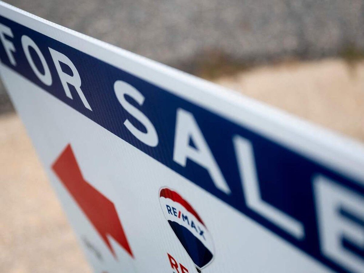 (FILES) In this file photo taken on July 06, 2021, a reality sign in front of a for sale home in Annapolis, Maryland. - Existing home sales slipped in August to the lowest in two years, marking a seventh straight monthly declines, according to industry data released on September 21, 2022, showing the continued slowing in the US housing as mortgage rates surge. Sales of all types of homes and condos fell 0.4 percent from July even while prices eased in the month, the National Association of Realtors (NAR) said.
