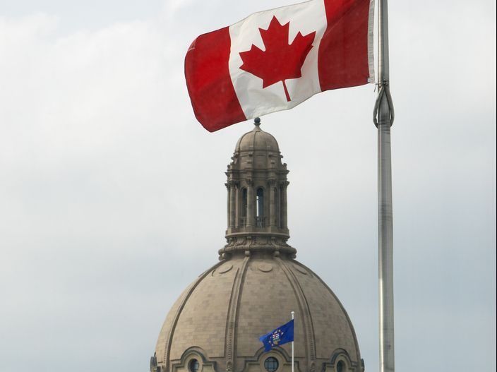A Canadian Flag and the dome of the Alberta Legislature are visible